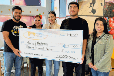 Winners Maria and Anthony with large check