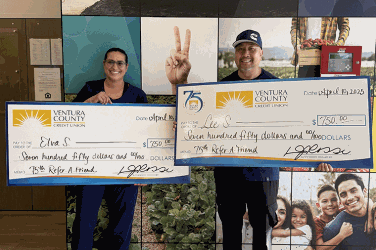 Winners holding checks