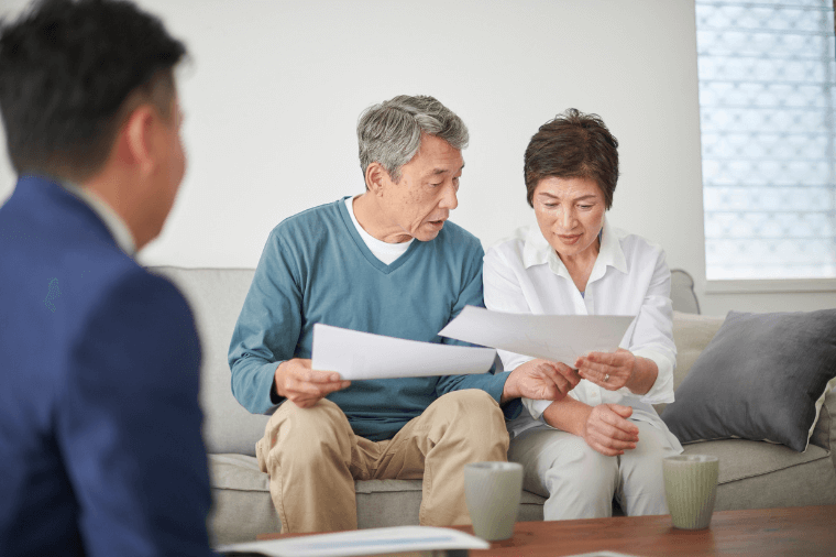 Elder-couple-reviewing-papers-with-Advisor Elder-couple-reviewing-papers-with-Advisor