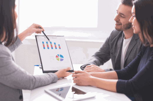 Young couple reviewing portfolio with advisor